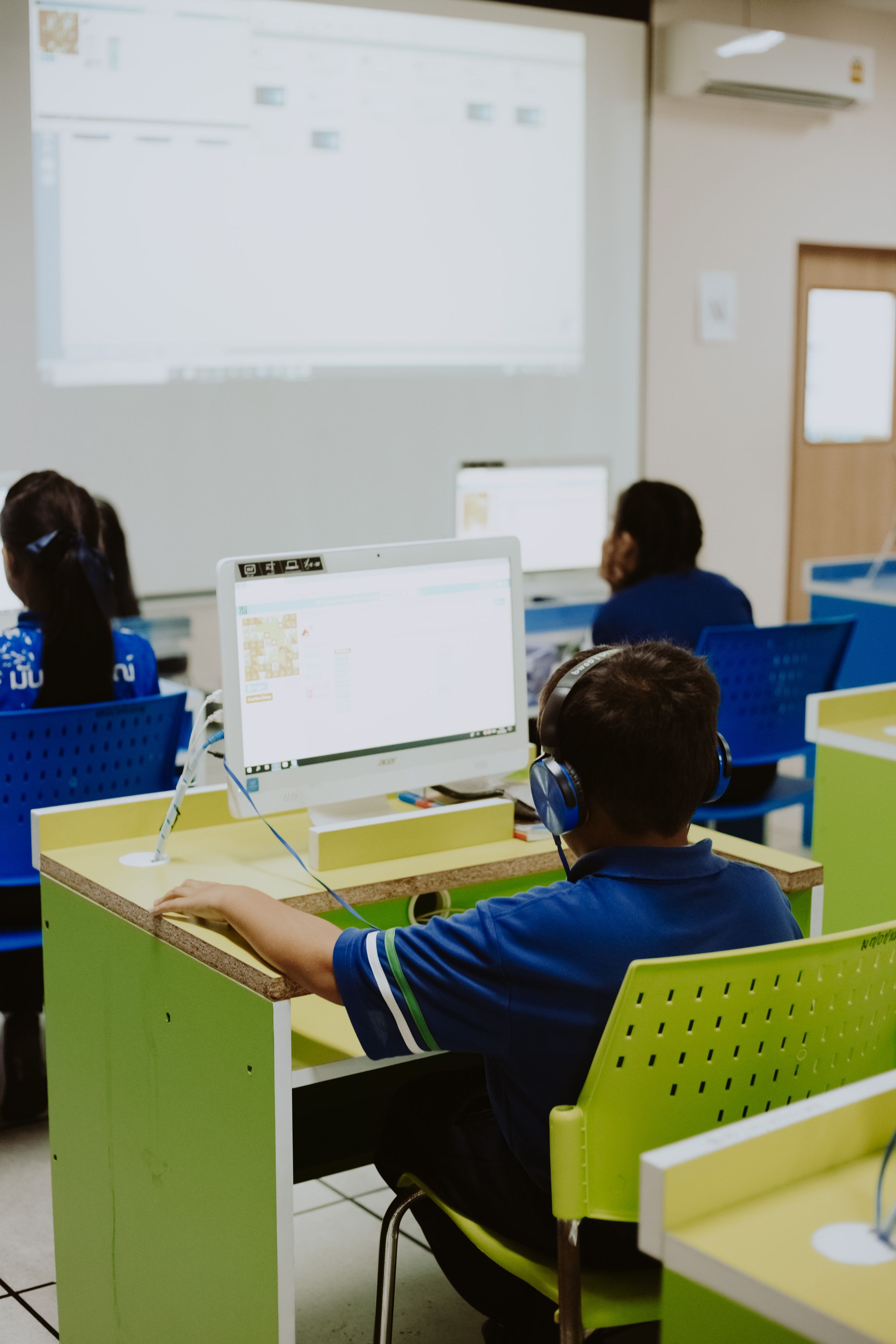 Students working at computers in a classroom
